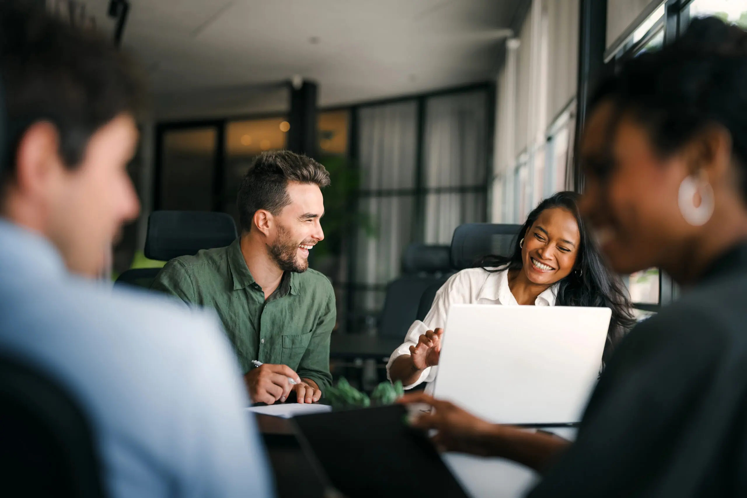 Group of young multi-ethnic startup business team collaborating on project in modern office Members
